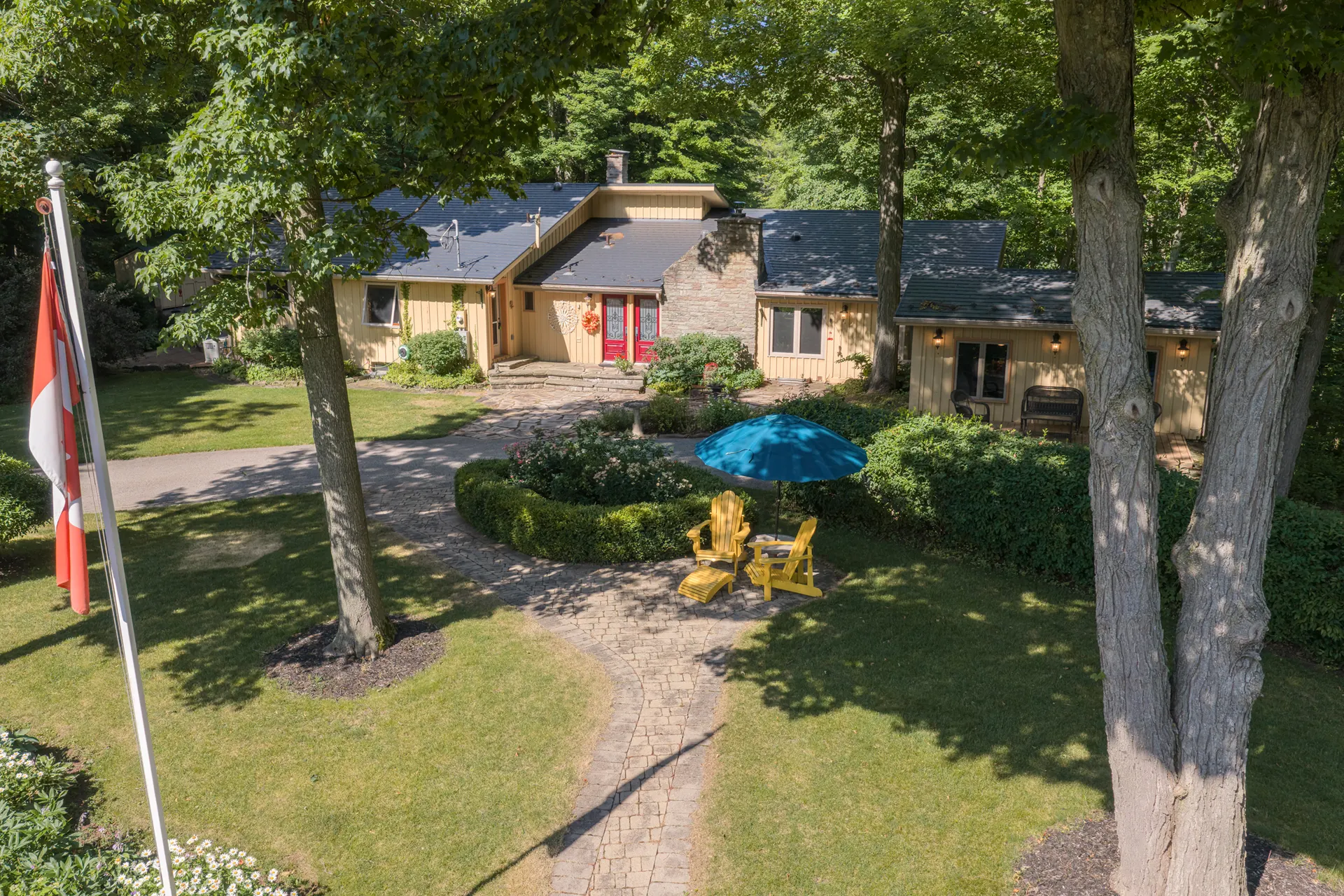 Aerial drone photograph of a wooded Heritage Road estate in the Greater Toronto Area. RCG Canada