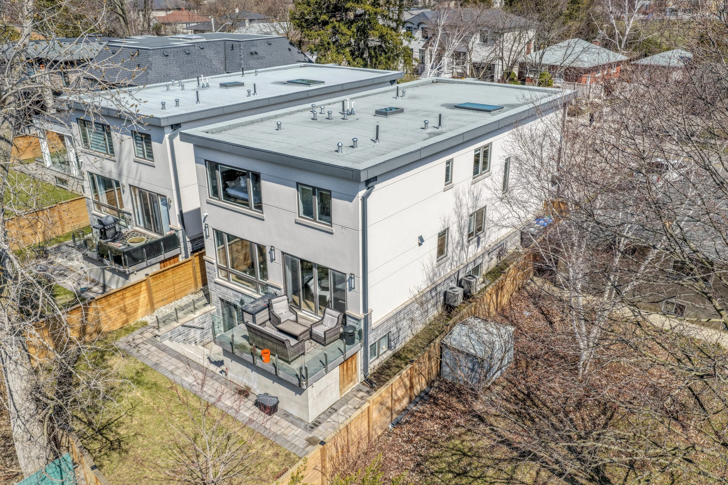 Aerial drone photograph of the rear elevation and backyard patio seating area - RCG Canada