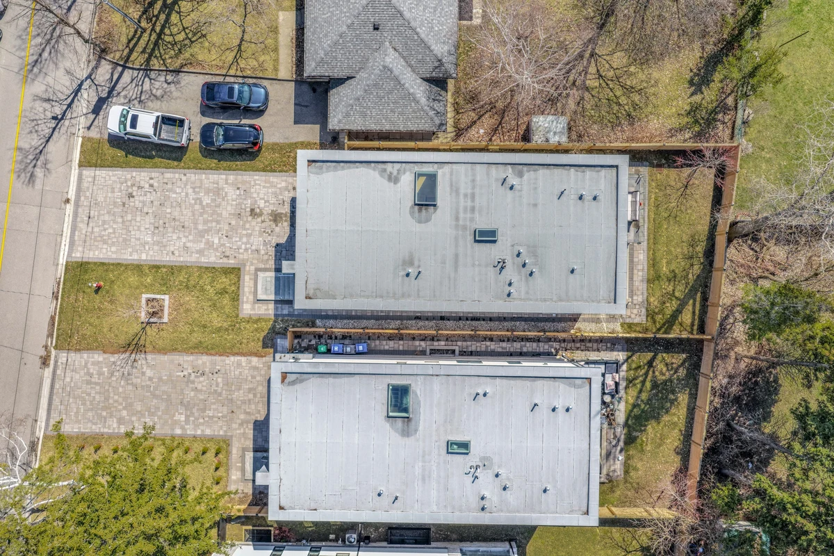 Top-down aerial drone photograph of twin modern rooflines and paver driveway of a Mississauga property. RCG Canada real estate photography