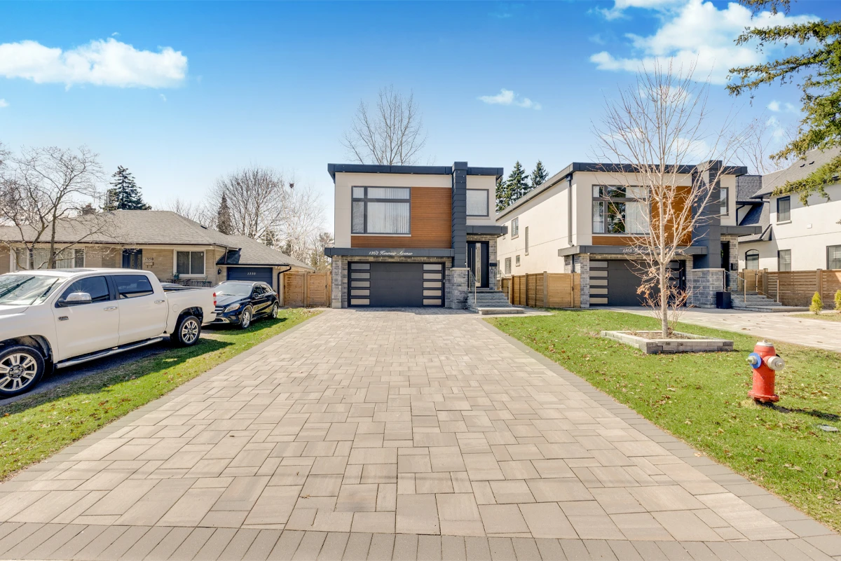 Wide street-level exterior of a modern two-storey custom home on Kenmuir Avenue in Mississauga, paver driveway leading to a dark double garage