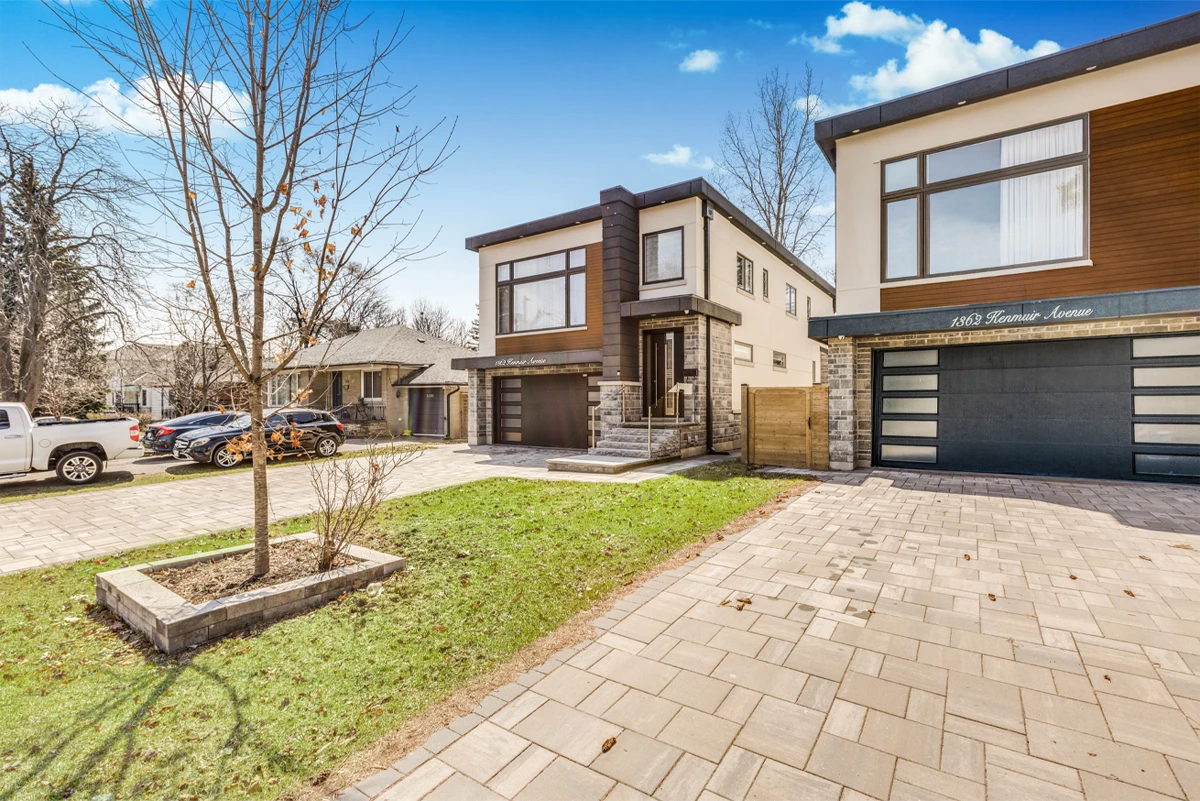 Angled exterior with the landscaped front lawn, young maple and stone walkway to the entrance - RCG Canada